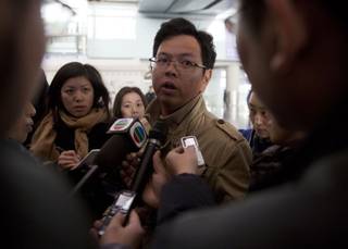 A Malaysian man who says he has relatives on board the missing Malaysian airline plane talks to journalists at Beijing's International Airport Beijing, China, Saturday, March 8, 2014. (AP Photo/Ng Han Guan)